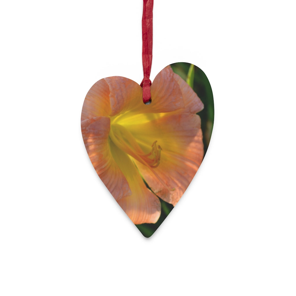 Peach and yellow flower wooden Christmas ornaments with red ribbons, showcasing whimsical shapes and a rustic design.