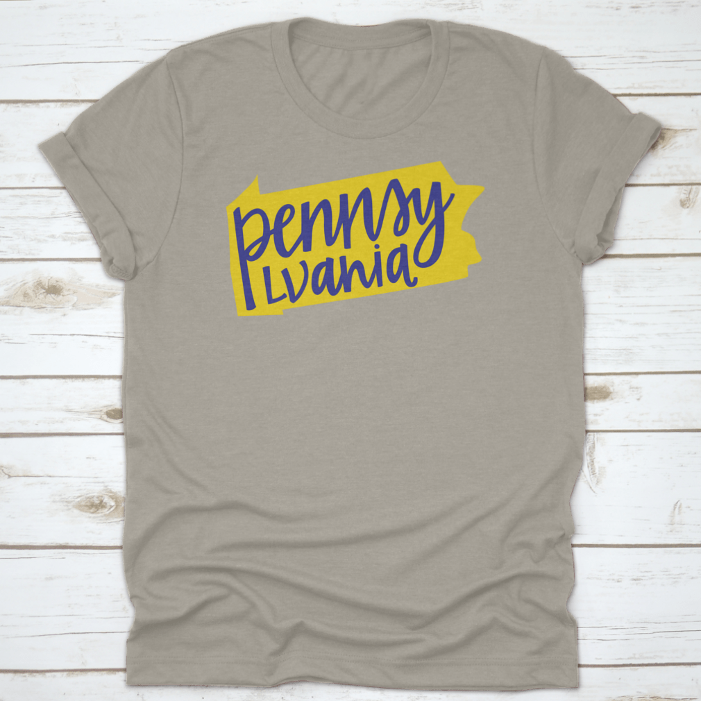 A stylish T-shirt featuring the Pennsylvania state outline and hand lettering design, made from soft cotton fabric.