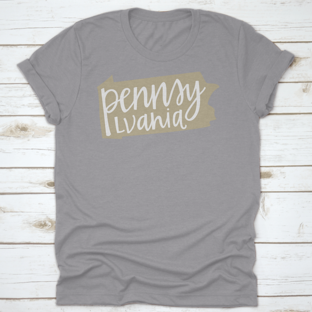 A stylish T-shirt featuring a Pennsylvania state outline and hand-lettering design, made from soft cotton fabric.