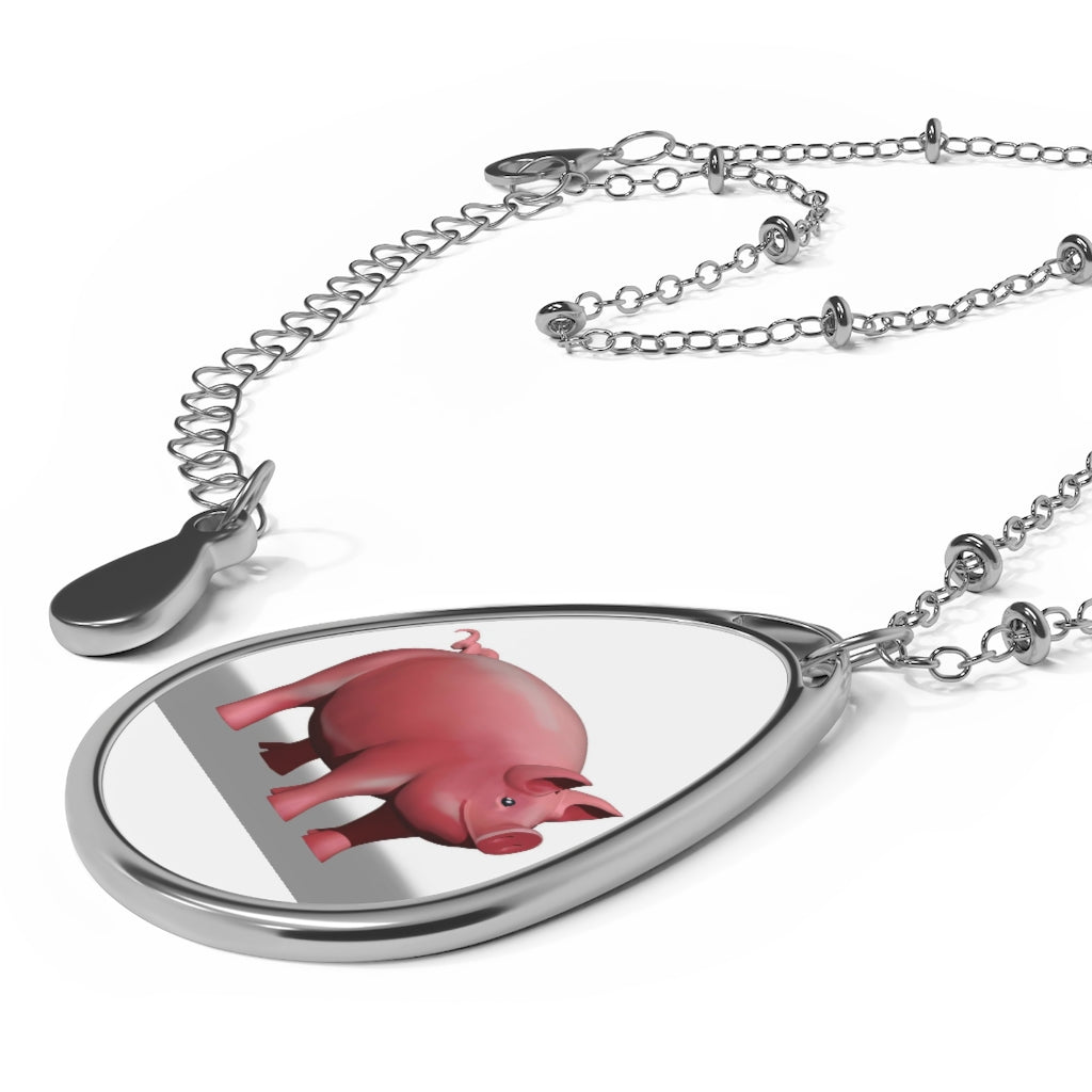 A stylish Pig Oval Necklace featuring a unique ellipse-shaped brass pendant with a white print base and a secure lobster clasp closure.