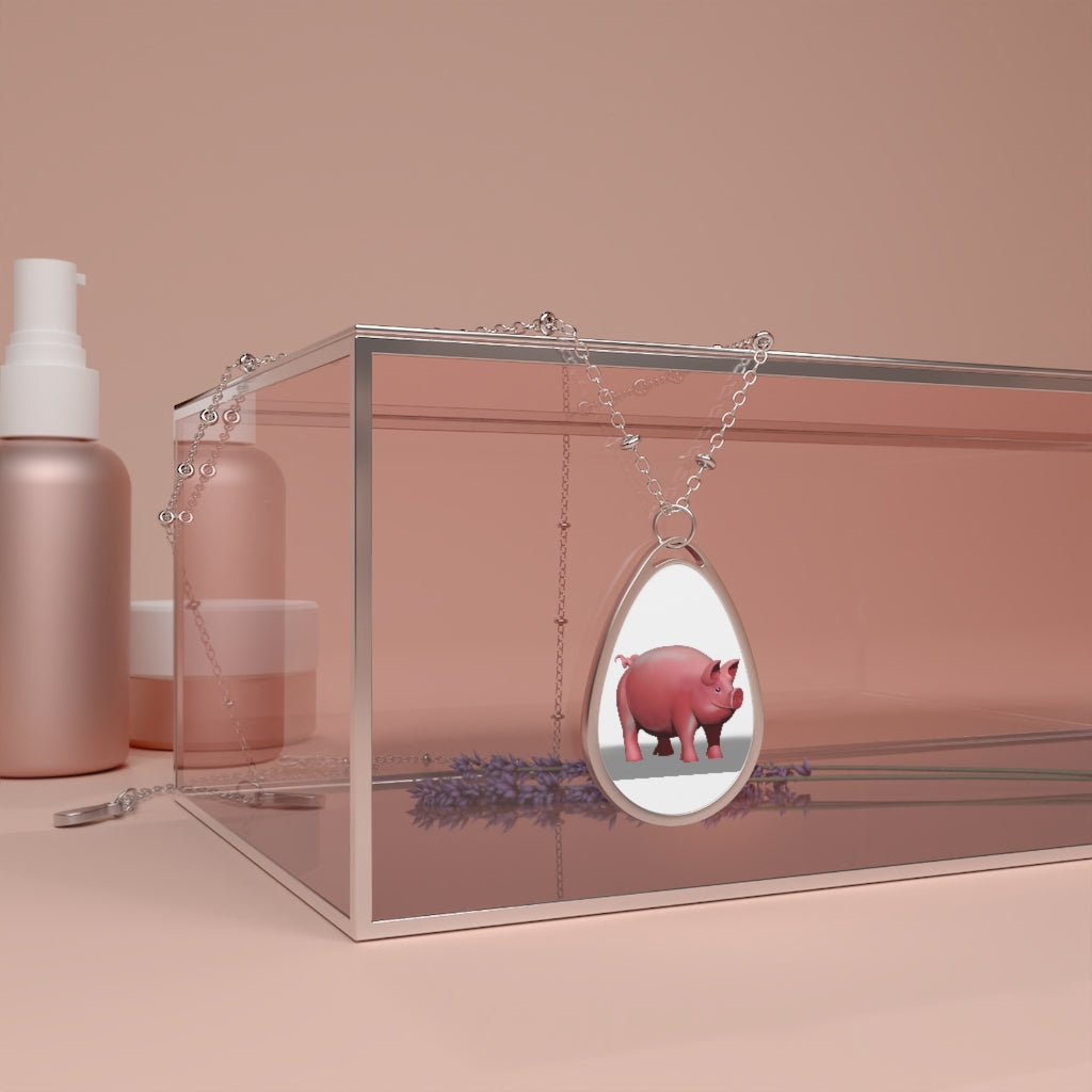 A stylish Pig Oval Necklace featuring a unique ellipse-shaped brass pendant with a white print base and a secure lobster clasp closure.