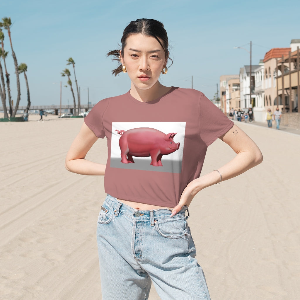 A stylish Pig Women's Flowy Cropped Tee in a light fabric, showcasing its modest crop and flowy fit, perfect for personalized designs.