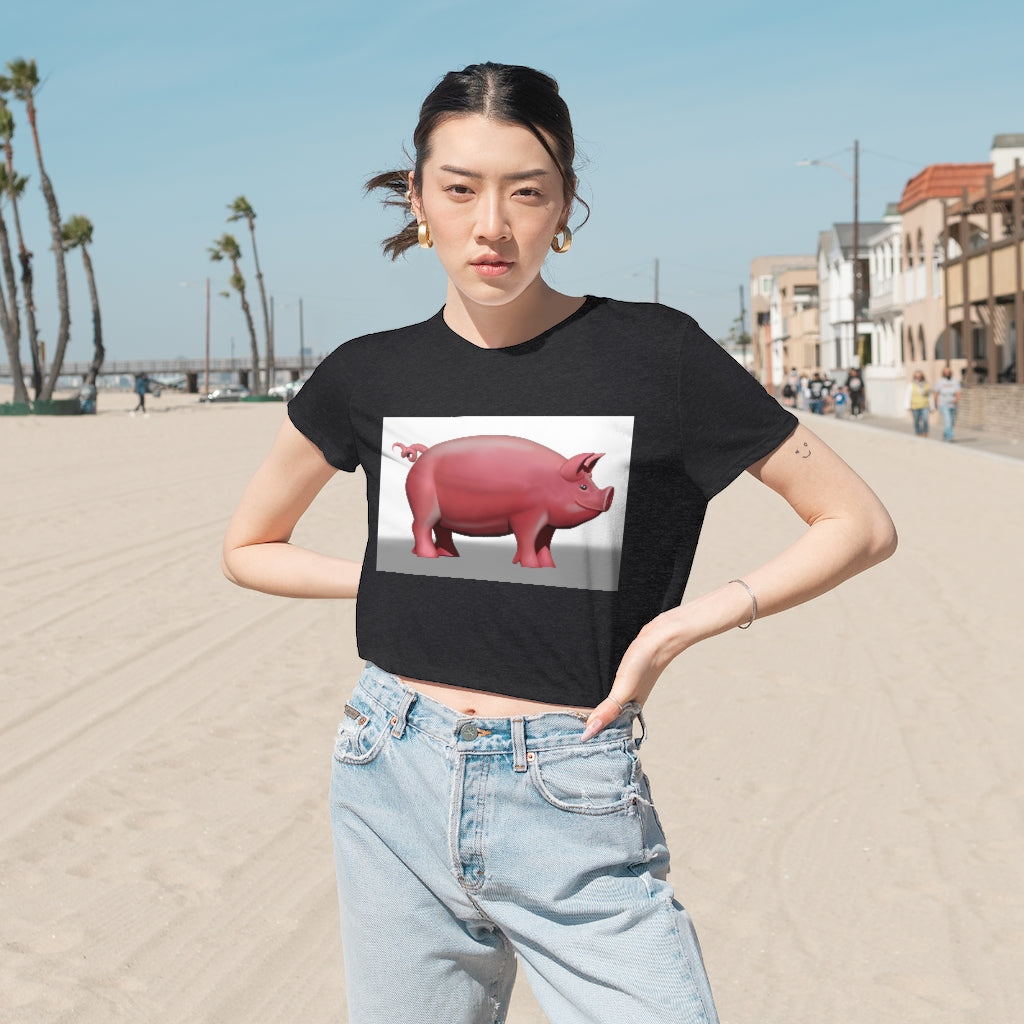 A stylish Pig Women's Flowy Cropped Tee in a light fabric, showcasing its modest crop and flowy fit, perfect for personalized designs.
