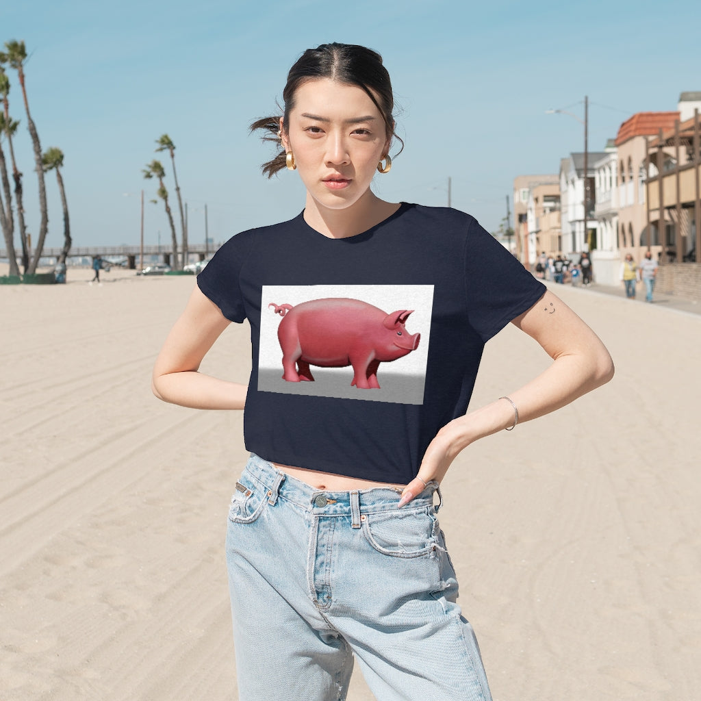 A stylish Pig Women's Flowy Cropped Tee in a light fabric, showcasing its modest crop and flowy fit, perfect for personalized designs.