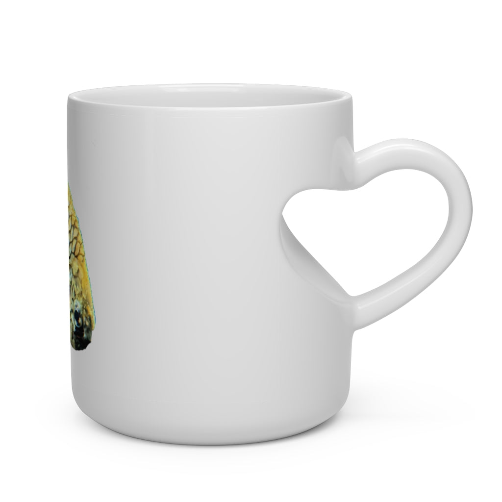 A white ceramic heart-shaped mug with a pineapple fish design and a heart-shaped handle, perfect for hot beverages.