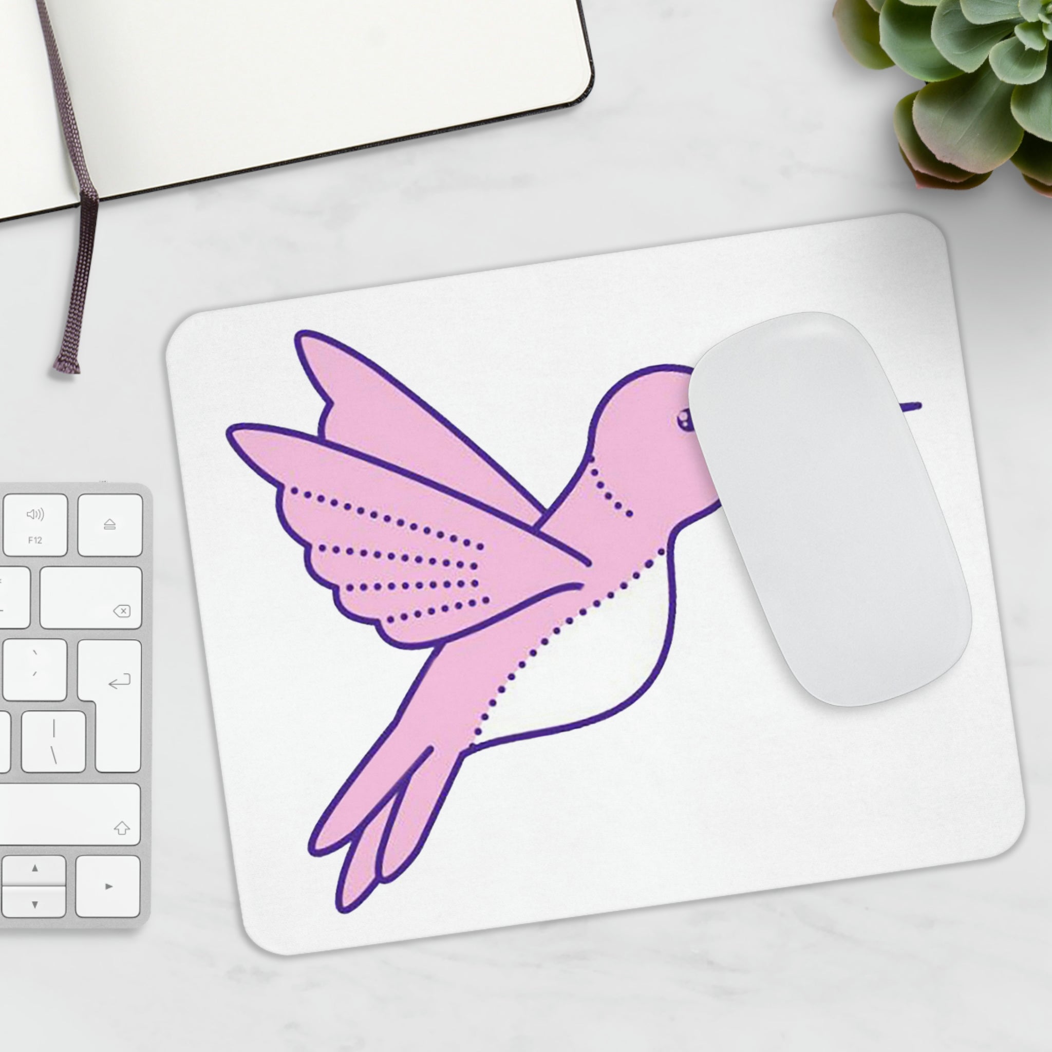 A vibrant pink and purple bird mouse pad featuring a colorful design, perfect for enhancing any workspace.