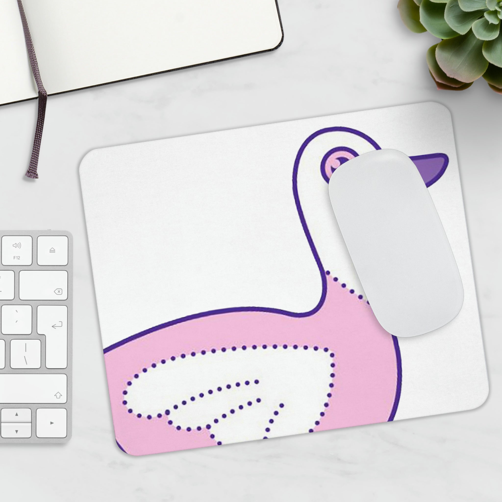 A vibrant pink and purple bird mouse pad featuring a whimsical bird design, perfect for enhancing any workspace.