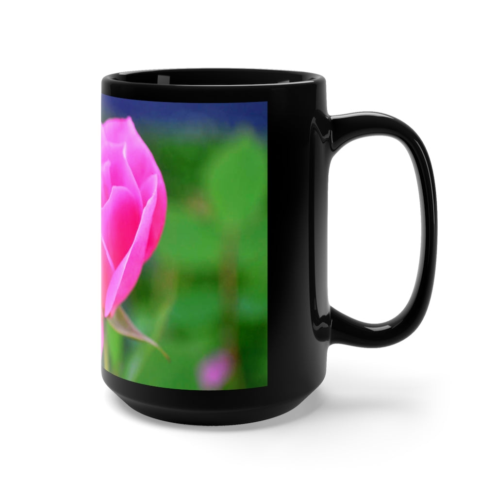 A stylish black ceramic mug featuring a vibrant pink flower design, perfect for coffee and tea lovers.