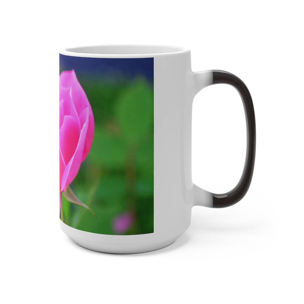 A pink flower color changing mug showcasing vibrant colors when filled with hot liquid, featuring a C-handle and rounded corners.