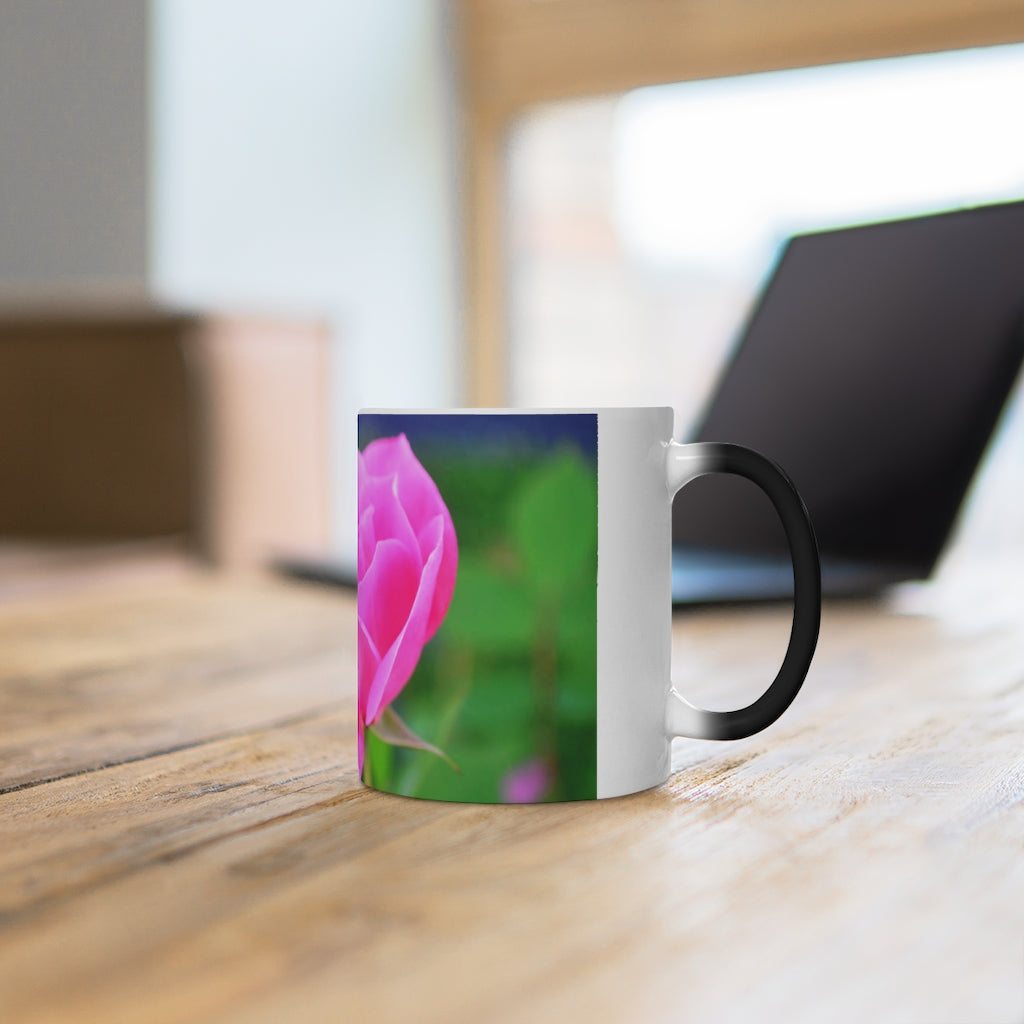 A pink flower color changing mug showcasing vibrant colors when filled with hot liquid, featuring a C-handle and rounded corners.