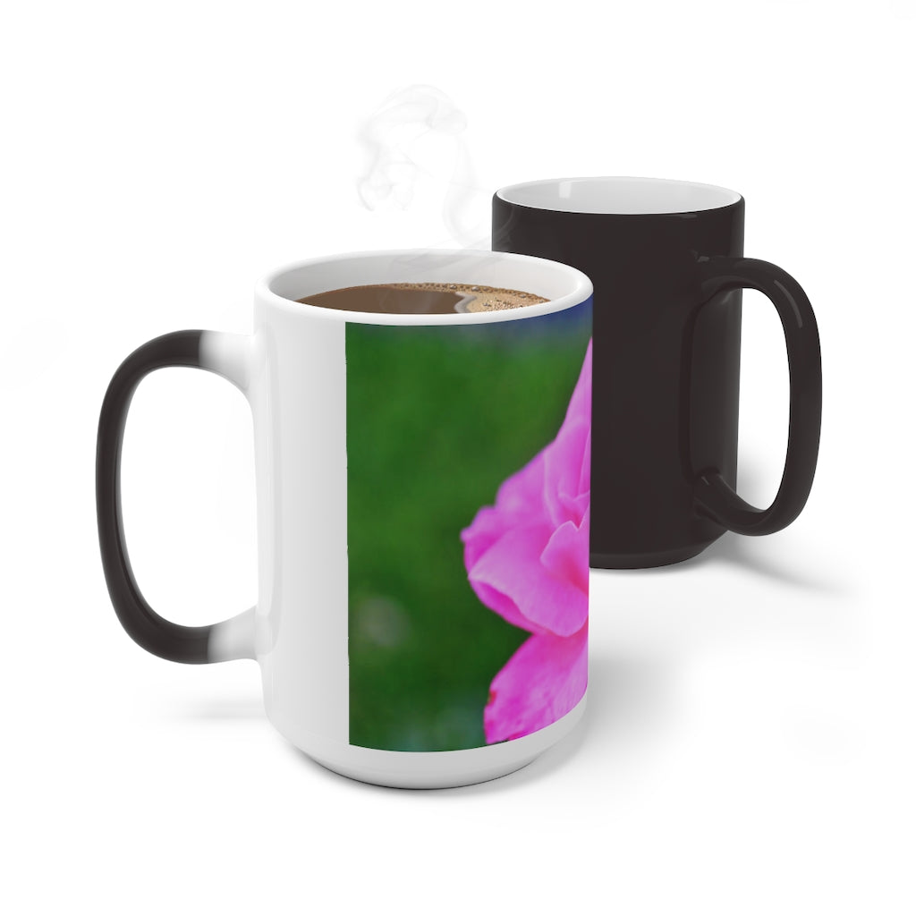 A pink flower color changing mug showcasing vibrant colors when filled with hot liquid, featuring a C-handle and rounded corners.