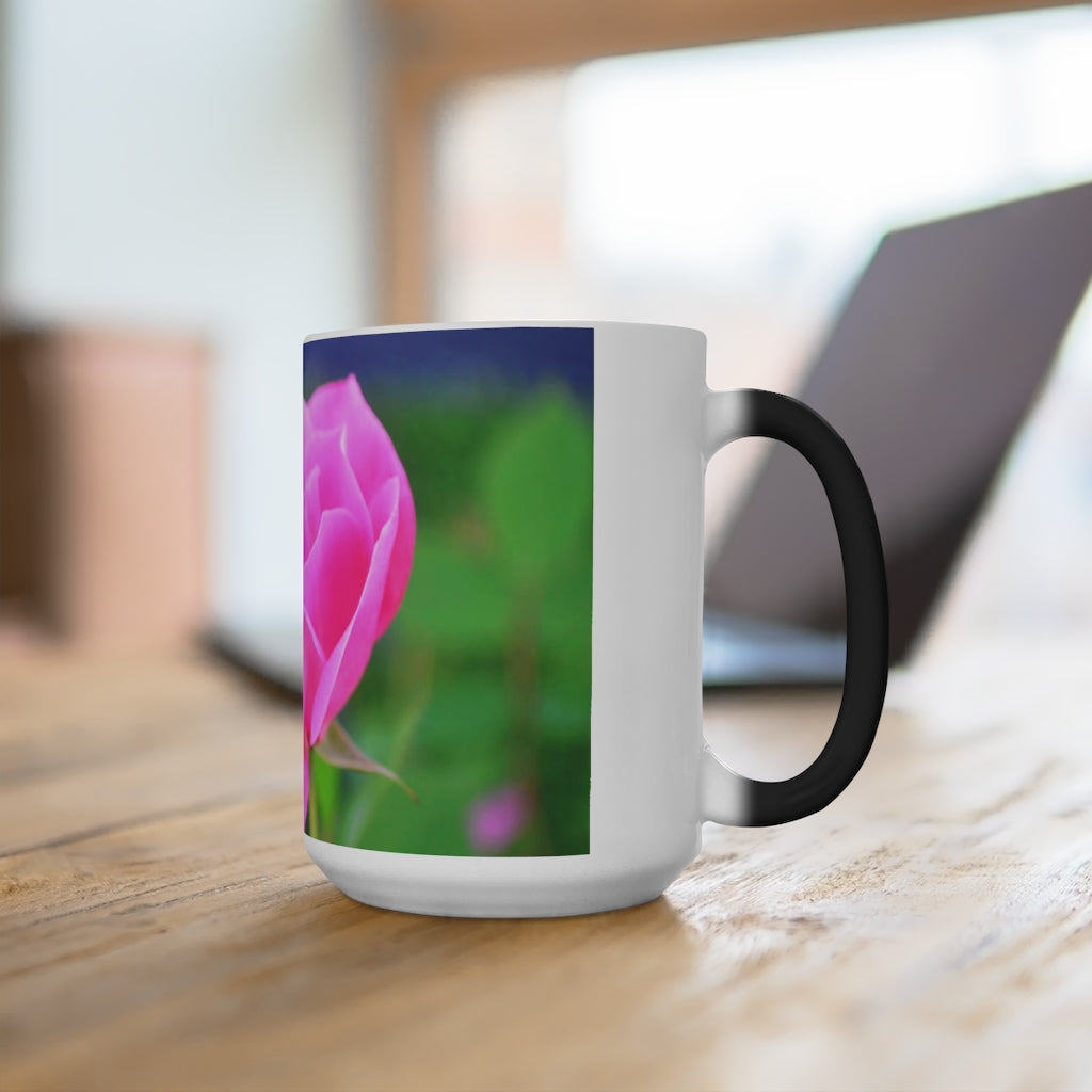 A pink flower color changing mug showcasing vibrant colors when filled with hot liquid, featuring a C-handle and rounded corners.