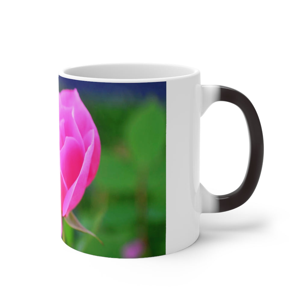 A pink flower color changing mug showcasing vibrant colors when filled with hot liquid, featuring a C-handle and rounded corners.