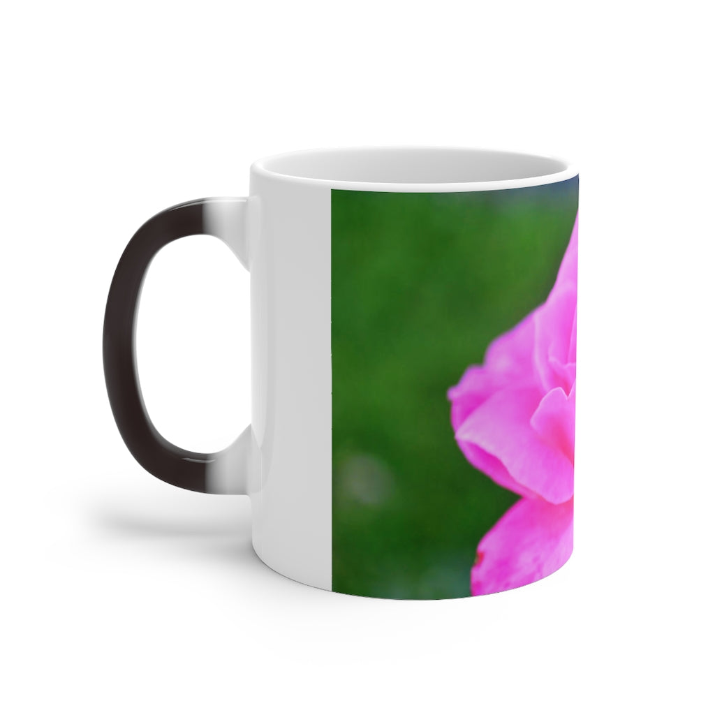 A pink flower color changing mug showcasing vibrant colors when filled with hot liquid, featuring a C-handle and rounded corners.