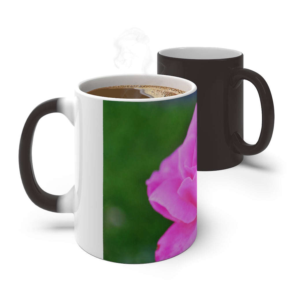 A pink flower color changing mug showcasing vibrant colors when filled with hot liquid, featuring a C-handle and rounded corners.