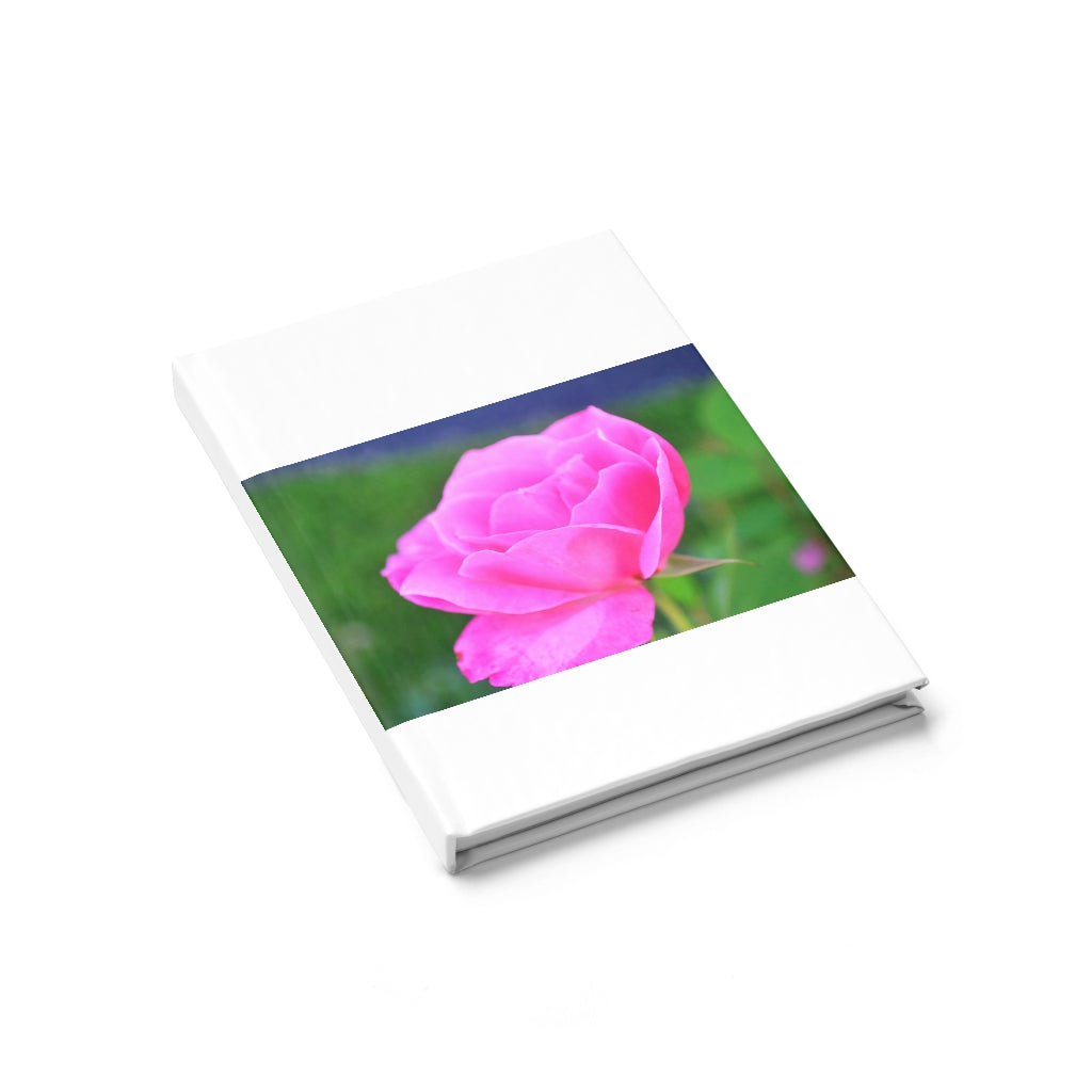 A beautiful hardcover journal featuring a pink flower design, showcasing ruled line pages for organized writing.