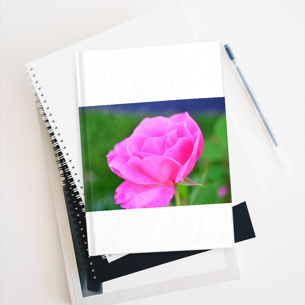 A beautiful hardcover journal featuring a pink flower design, showcasing ruled line pages for organized writing.