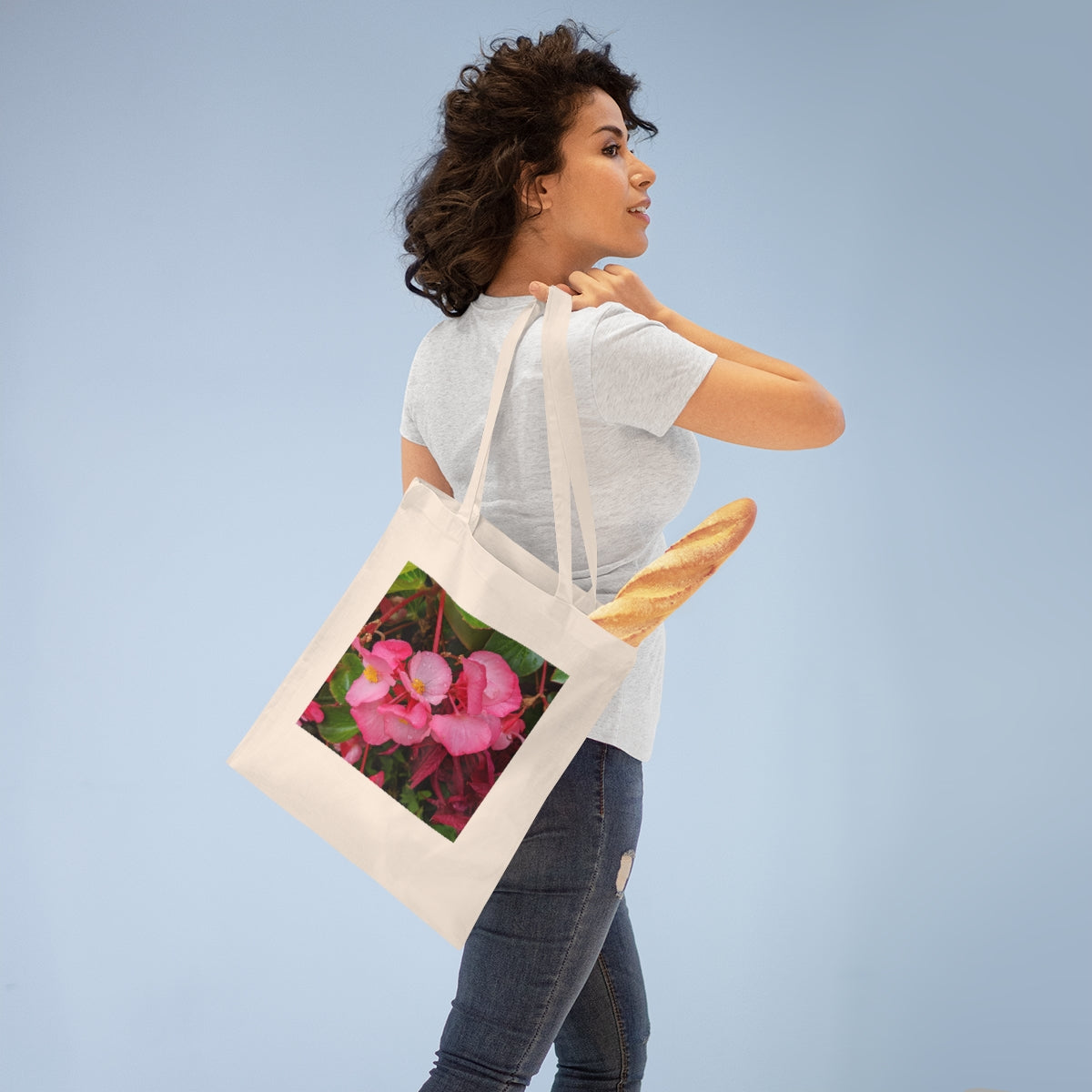 A stylish Pink Flowers Tote Bag made of 100% cotton, featuring long handles and a vibrant floral design.
