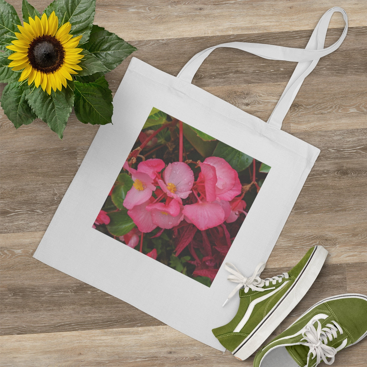 A stylish Pink Flowers Tote Bag made of 100% cotton, featuring long handles and a vibrant floral design.