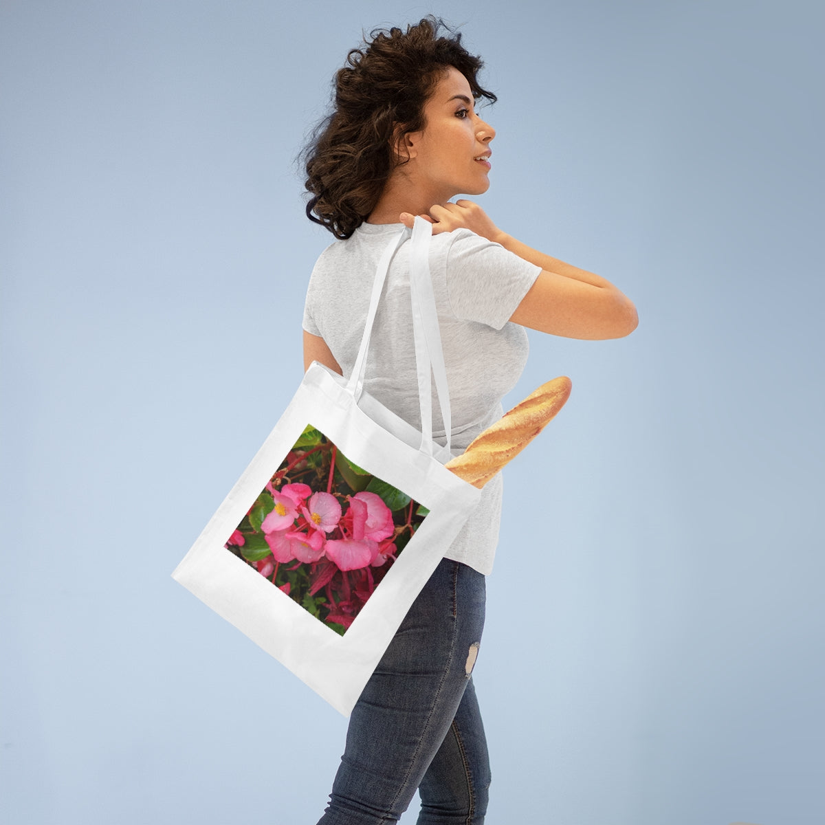 A stylish Pink Flowers Tote Bag made of 100% cotton, featuring long handles and a vibrant floral design.