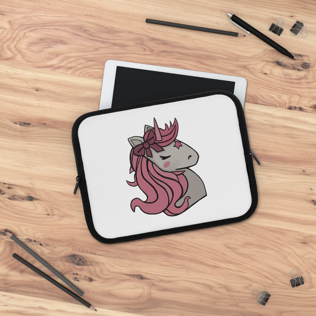 A stylish pink laptop sleeve featuring a unicorn head design, made from smooth neoprene with a black back.