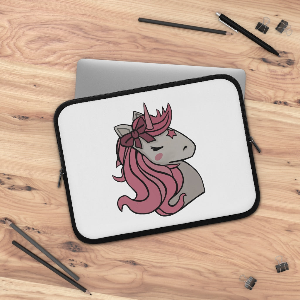 A stylish pink laptop sleeve featuring a unicorn head design, made from smooth neoprene with a black back.