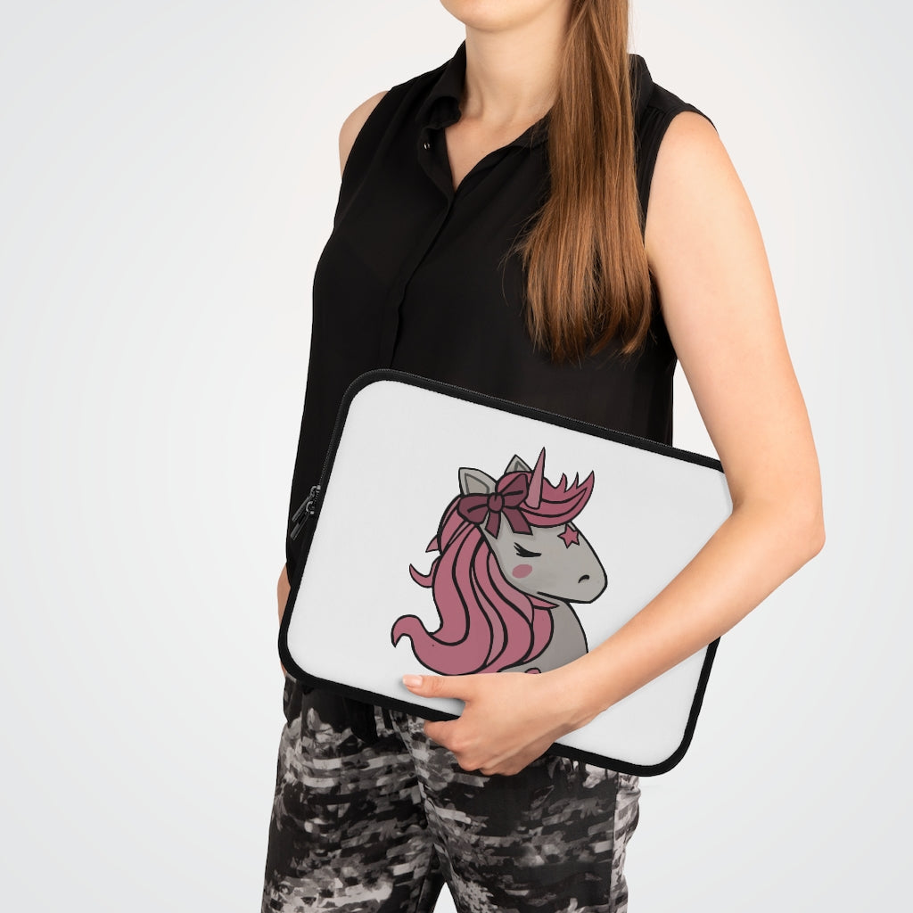 A stylish pink laptop sleeve featuring a unicorn head design, made from smooth neoprene with a black back.