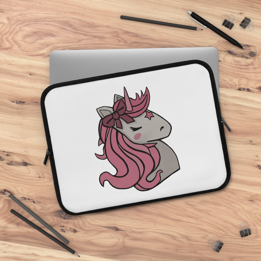 A stylish pink laptop sleeve featuring a unicorn head design, made from smooth neoprene with a black back.