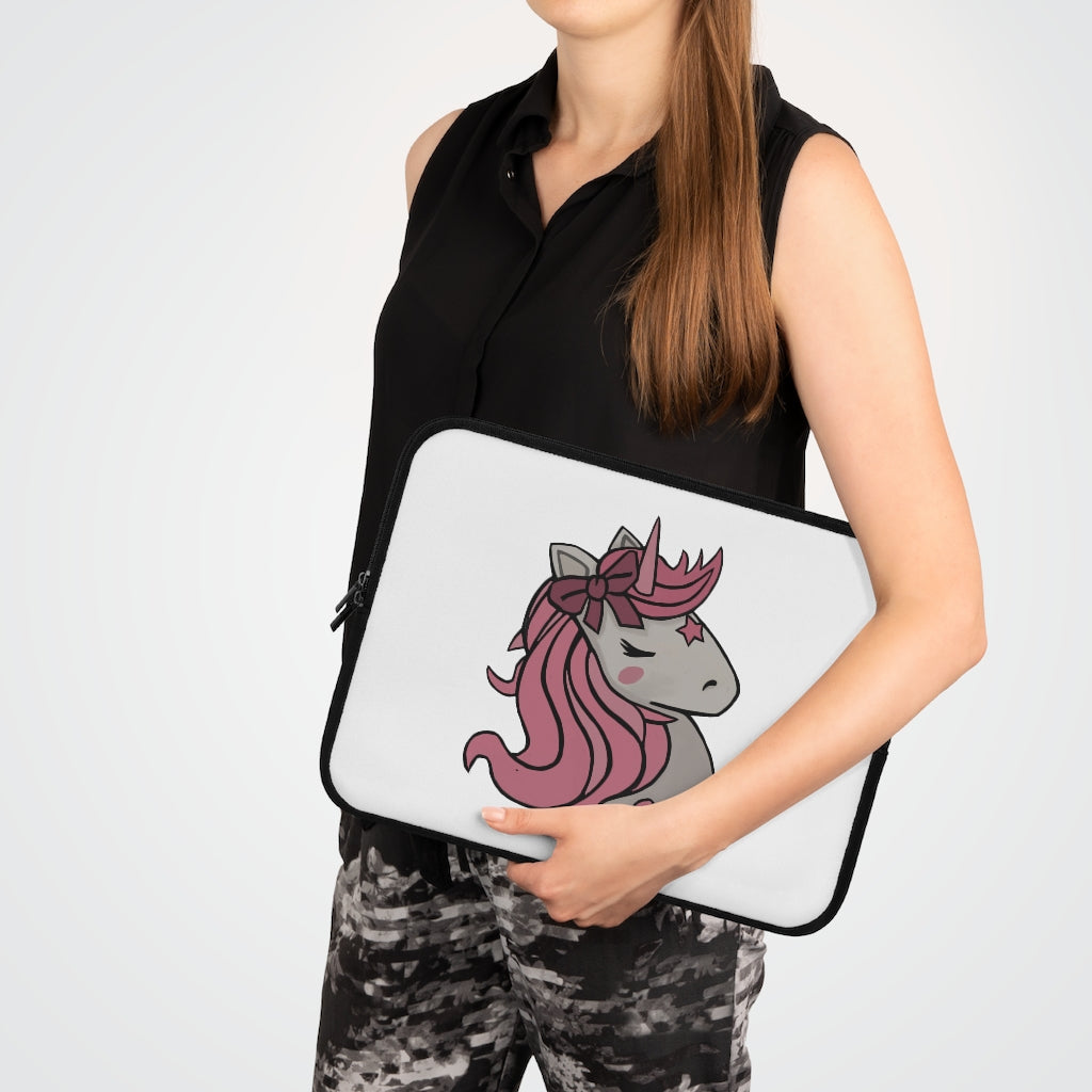 A stylish pink laptop sleeve featuring a unicorn head design, made from smooth neoprene with a black back.