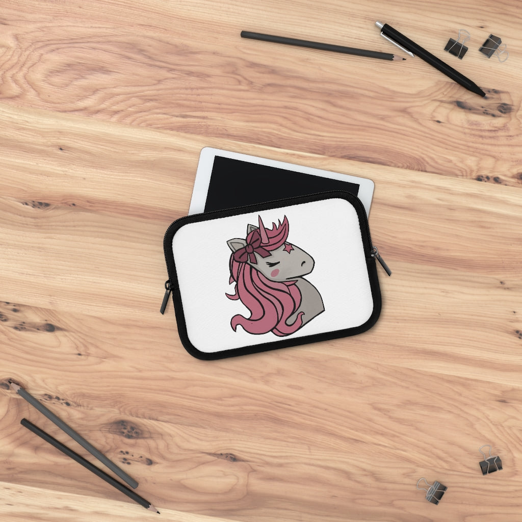 A stylish pink laptop sleeve featuring a unicorn head design, made from smooth neoprene with a black back.