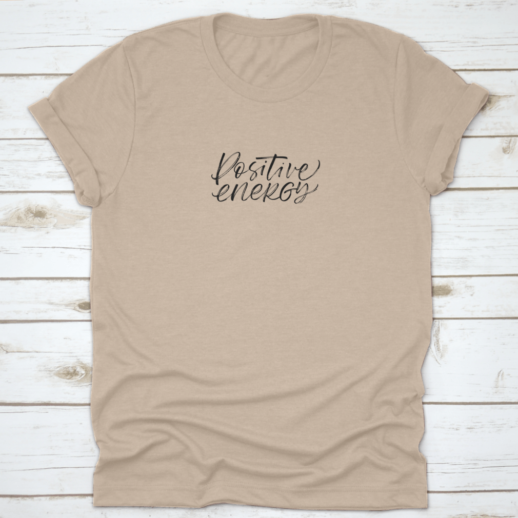 A stylish ink illustration featuring a positive energy phrase in modern brush calligraphy on a soft cotton fabric, showcasing a blend of artistic design and comfort.