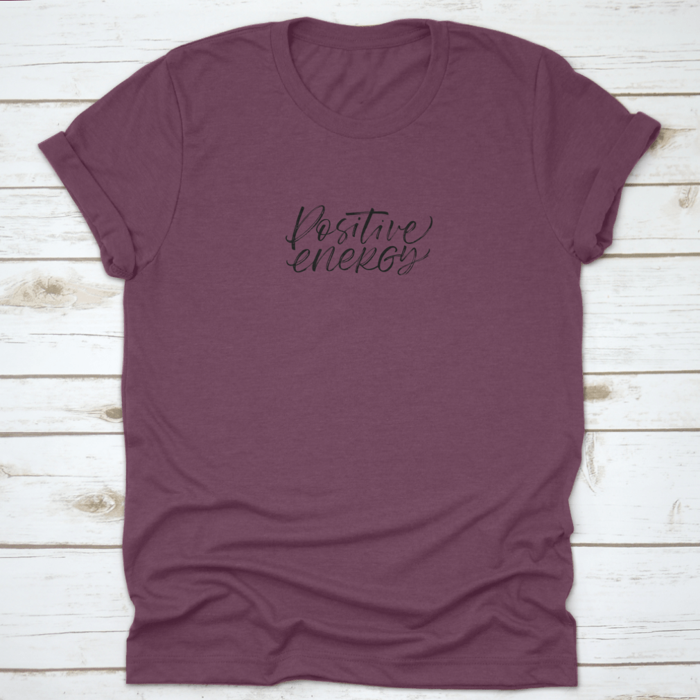 A stylish ink illustration featuring a positive energy phrase in modern brush calligraphy on a soft cotton fabric, showcasing a blend of artistic design and comfort.