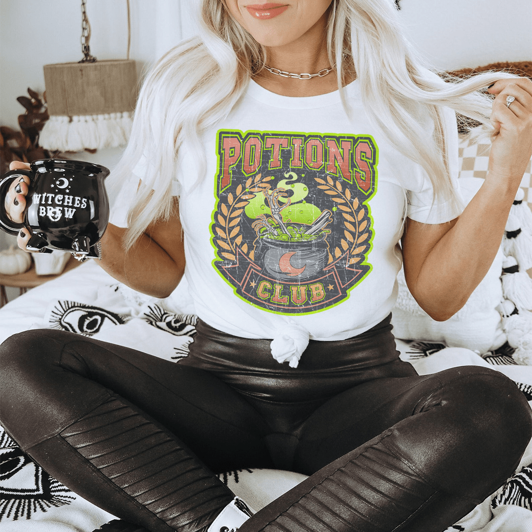 Potions Club Tee featuring a spooky Halloween design, made from 100% soft cotton, perfect for festive celebrations.