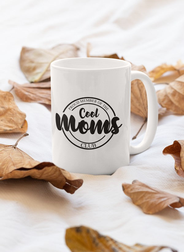 A stylish 11oz ceramic mug with a glossy finish, featuring the text 'Proud Member Of The Cool Moms Club' and a sturdy handle.