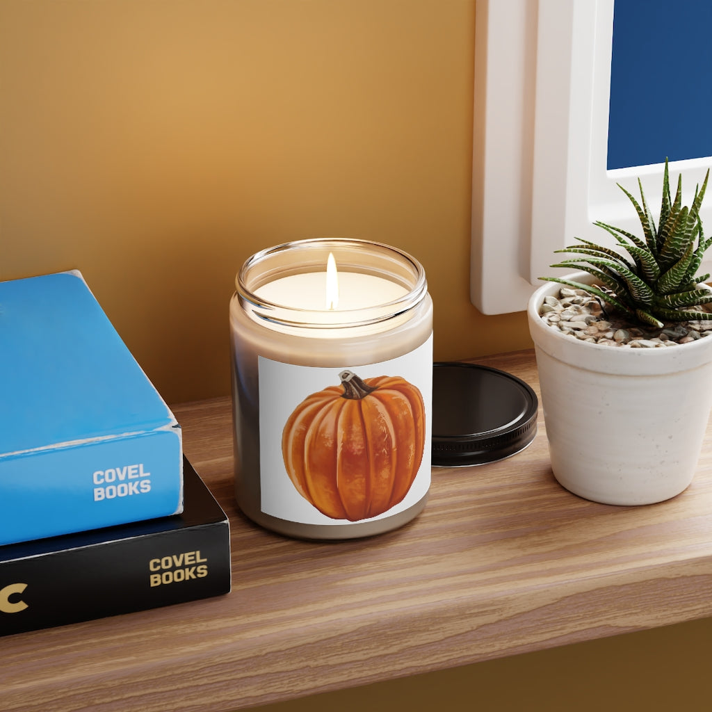 A beautifully crafted Pumpkin Scented Candle in a glass container, showcasing its warm orange hue and elegant label.