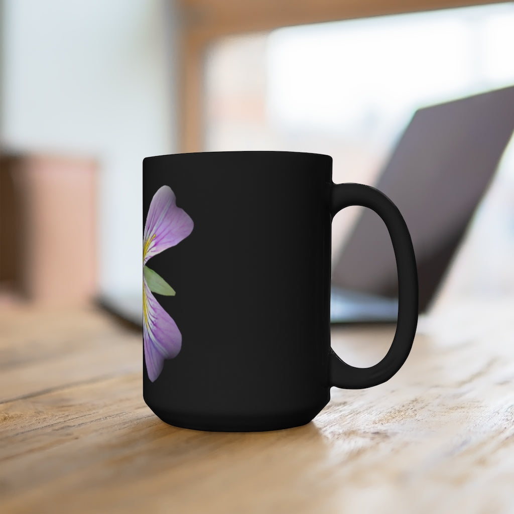 A stylish black ceramic mug featuring a vibrant purple flower design, perfect for coffee and tea lovers.