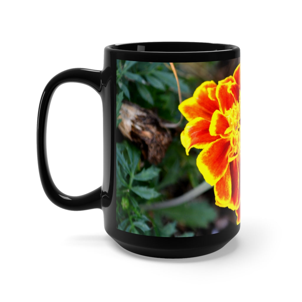 A stylish black ceramic mug featuring vibrant red and yellow flowers, perfect for coffee and tea lovers.