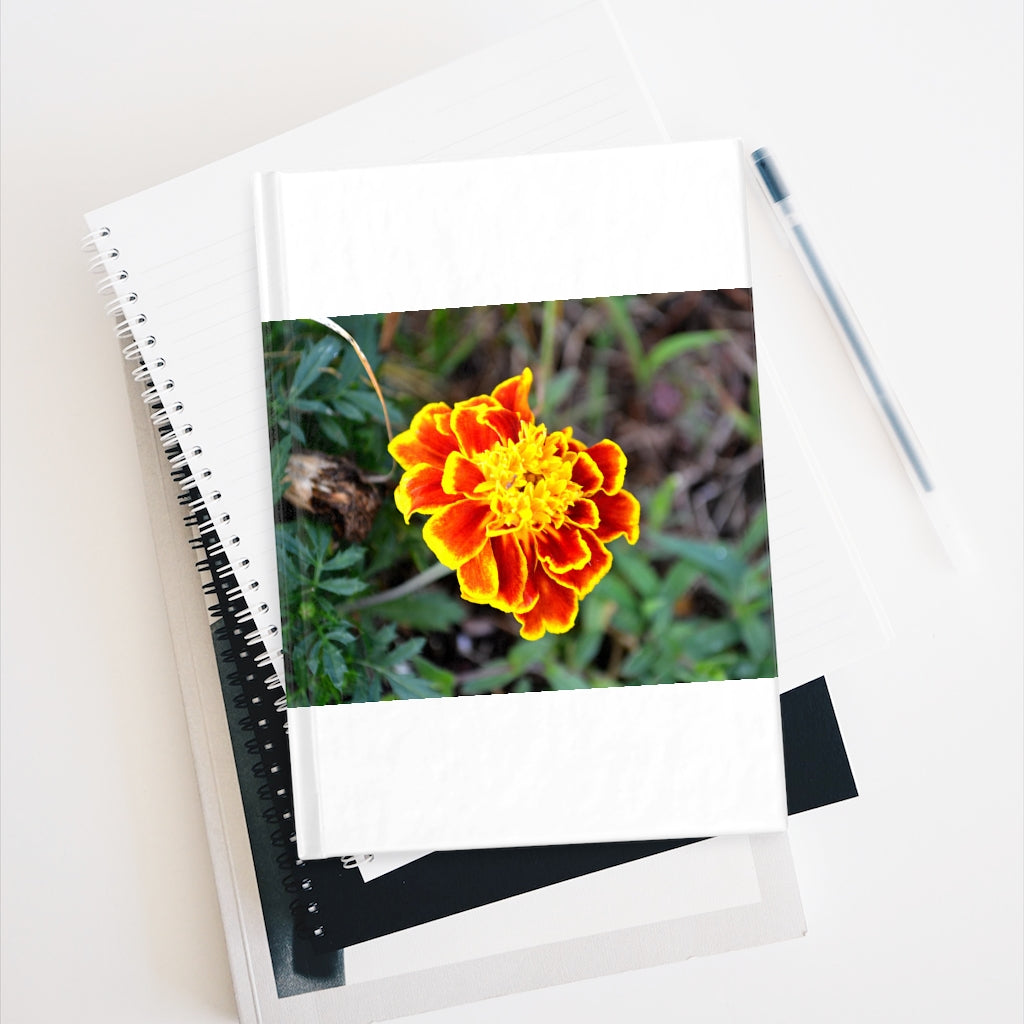 A vibrant red and yellow flower journal with a hardcover, featuring a wraparound print and blank pages for creativity.