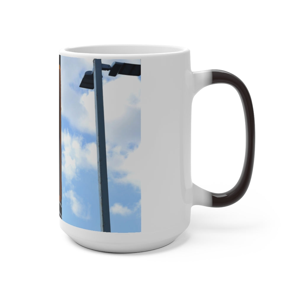 A white ceramic mug that changes color when filled with hot liquid, showcasing its unique design and C-handle.