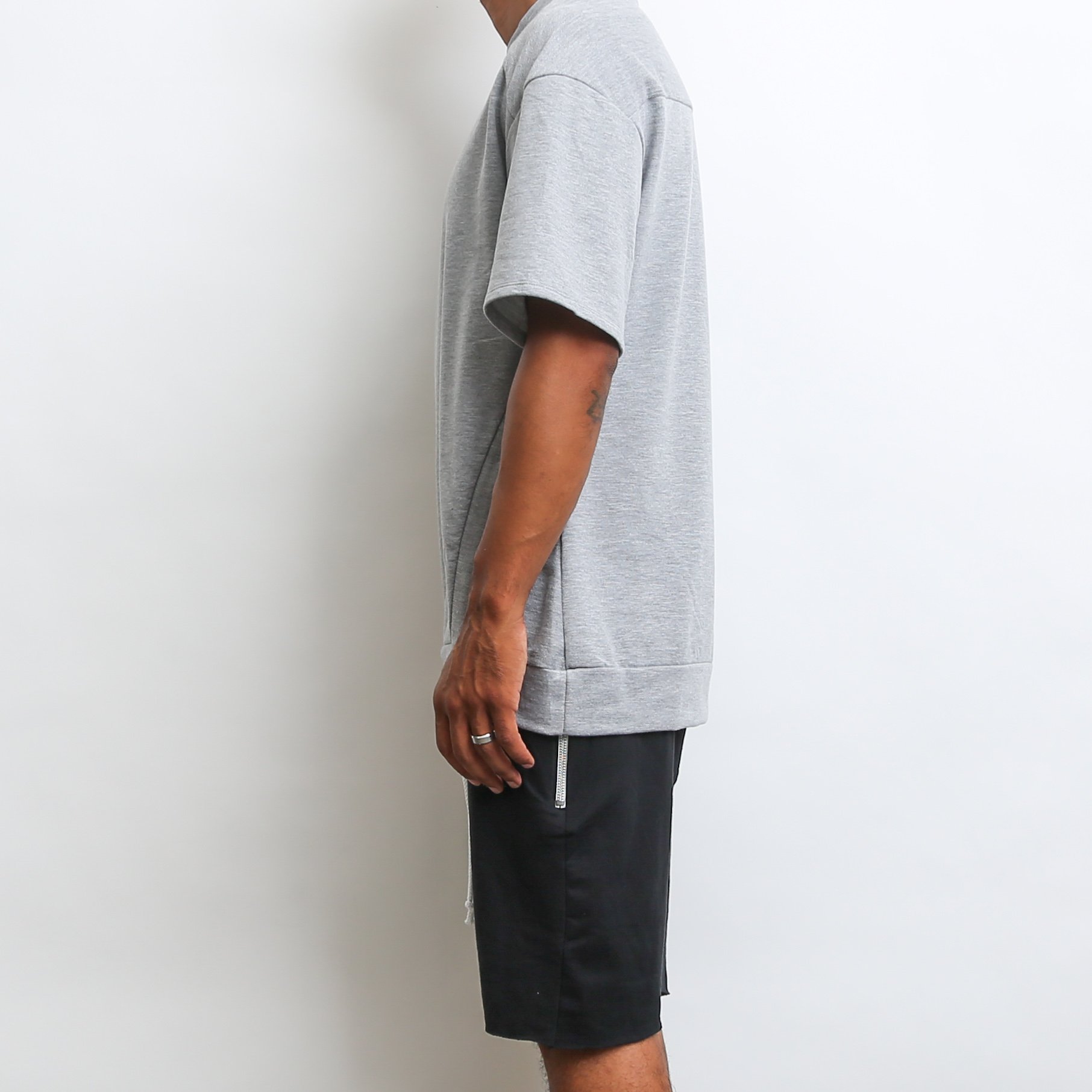 A stylish grey oversized 1/2 sleeve tee made from 100% cotton, perfect for casual wear.