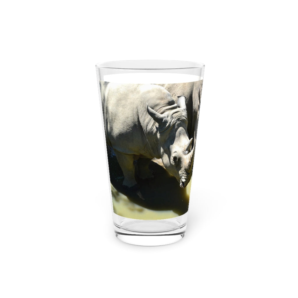 A clear 16oz Rhinos Pint Glass showcasing its sleek design, perfect for personalized drinks.