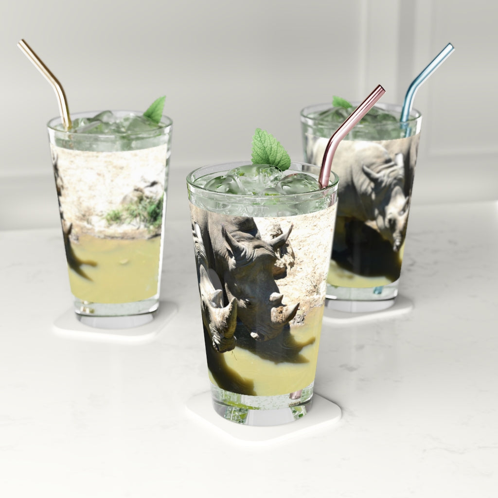 A clear 16oz Rhinos Pint Glass showcasing its sleek design, perfect for personalized drinks.