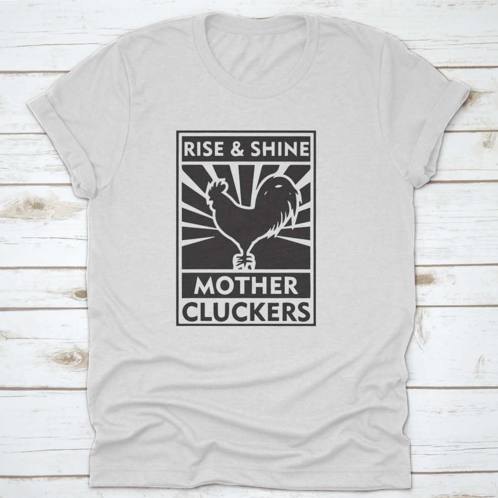 Rise And Shine Mother Cluckers T-Shirt featuring a humorous logo design, made from soft cotton fabric.