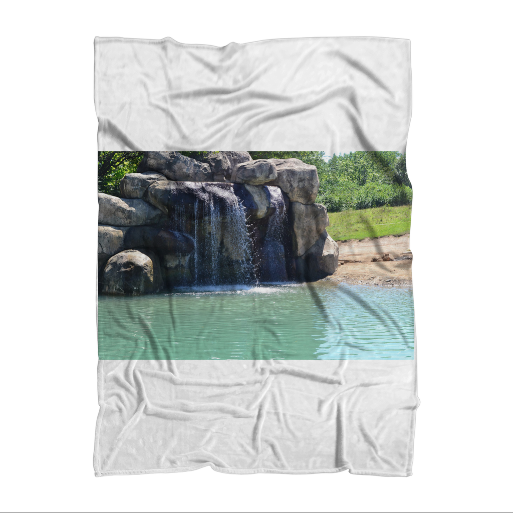 Rock Waterfall Sublimation Throw Blanket made of soft polar fleece, featuring a vibrant waterfall design, perfect for cozying up.
