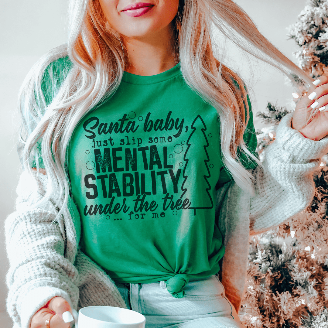 Santa Put Some Mental Stability Under The Tree T-Shirt displayed on a mannequin, showcasing its soft cotton fabric and festive design.
