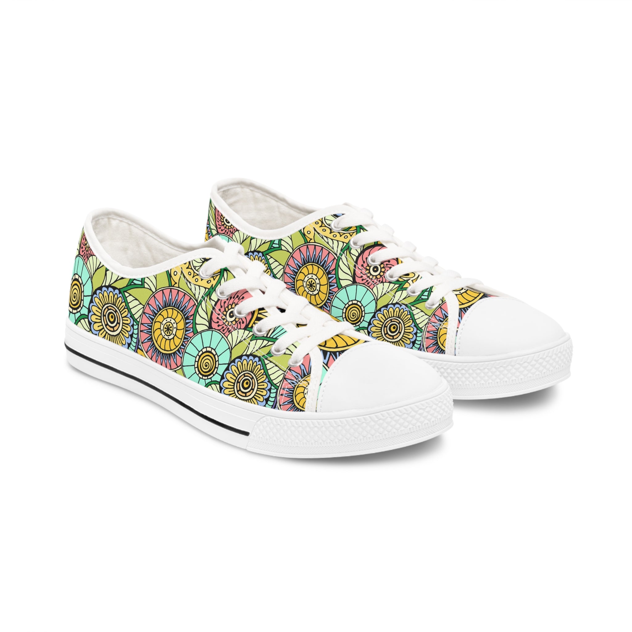 A pair of Seamless Flowers Women's Low Top Sneakers in black and white, featuring breathable canvas, memory foam insoles, and stylish silver eyelets.