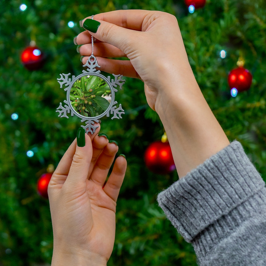 Seeds and Green Leaves Pewter Snowflake Ornament with silver-toned hanging string, showcasing intricate snowflake design.