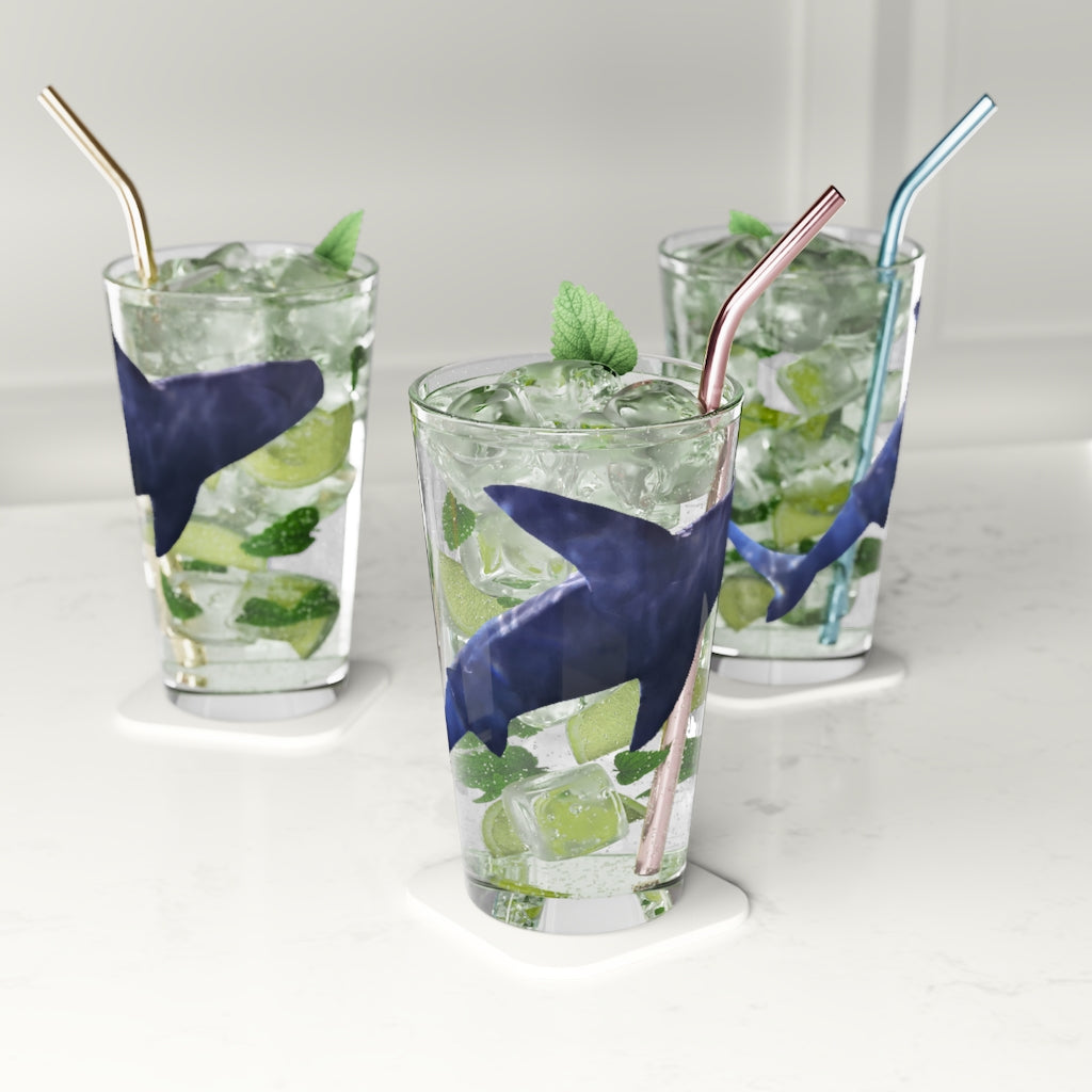 A clear 16oz Shark Pint Glass showcasing a custom printed design, ideal for beverages.