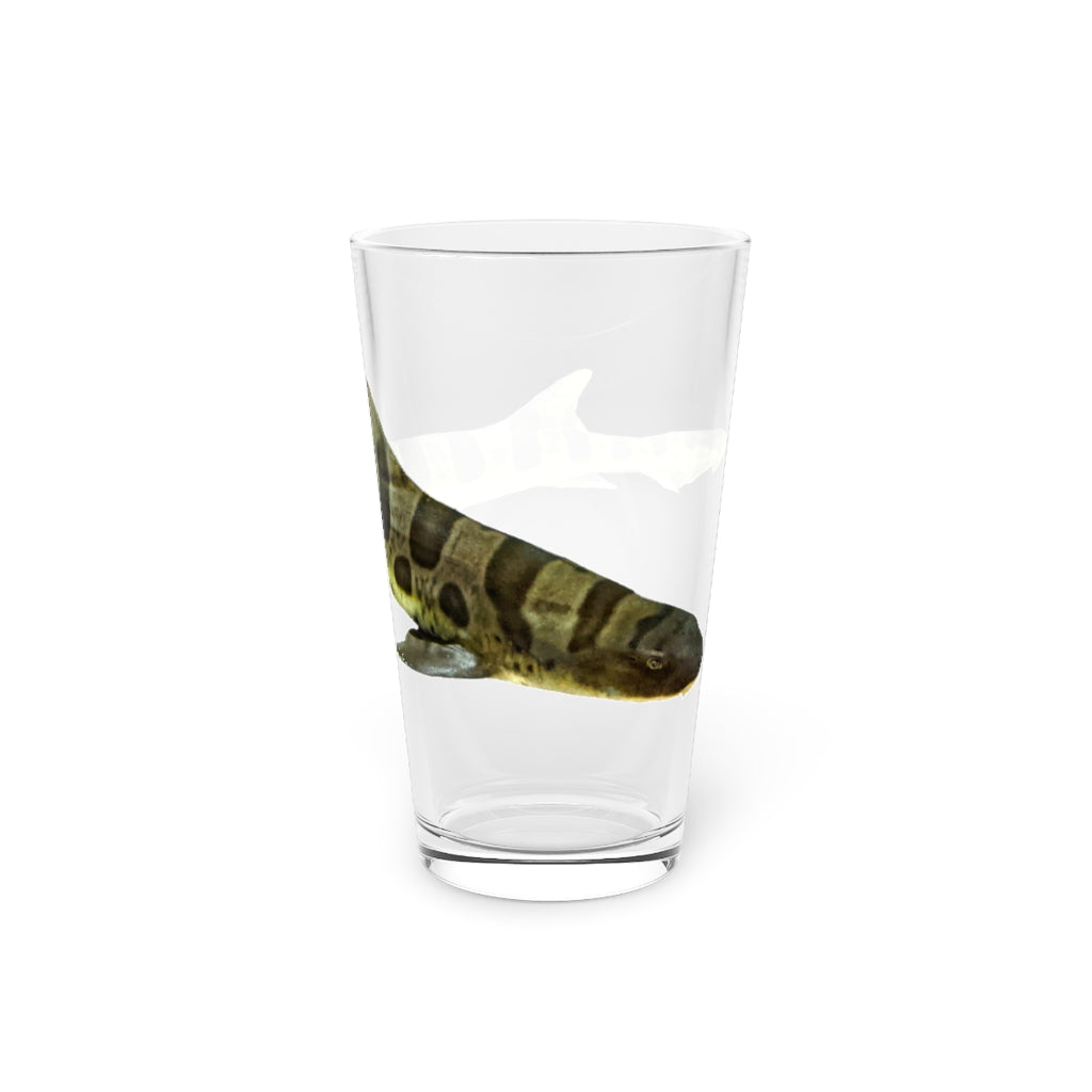 A clear 16oz Shark Pint Glass showcasing a customizable design, perfect for beverages.