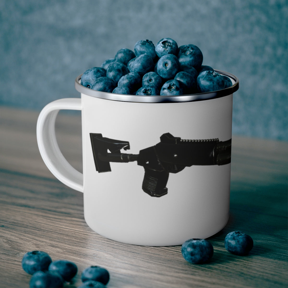 A stylish Shot Gun Ca enamel mug with a C-handle, showcasing a personalized design, perfect for outdoor adventures.